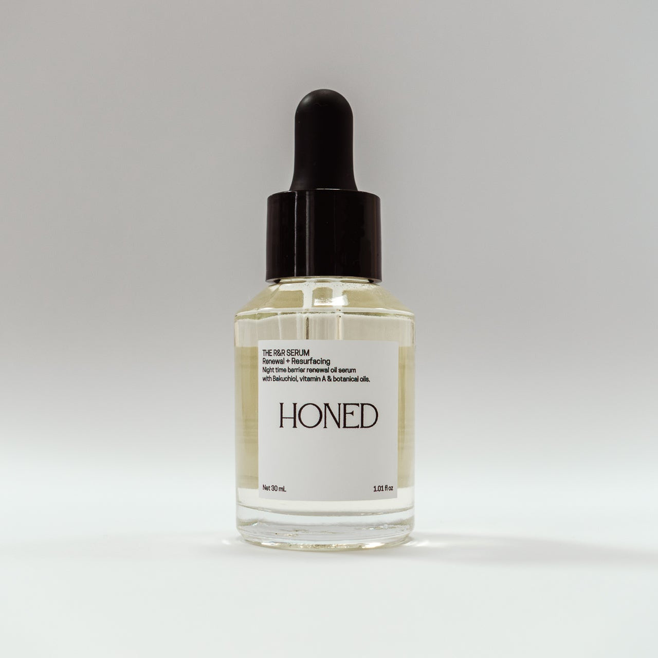 Bottle of 'Honed' skincare serum with vitamin A and Bakuchiol in a glass bottle with dropper