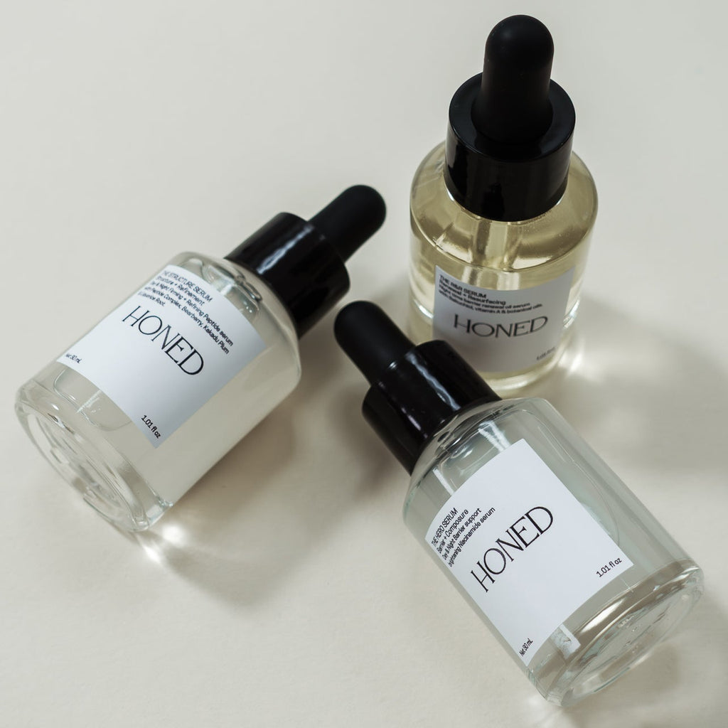 Peptide, Niacinamide and bakuchiol serum 'Honed' skincare bottles with droppers on a light background
